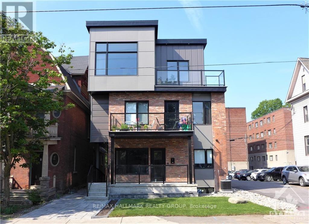 A modern two-story house with a balcony is for sale.