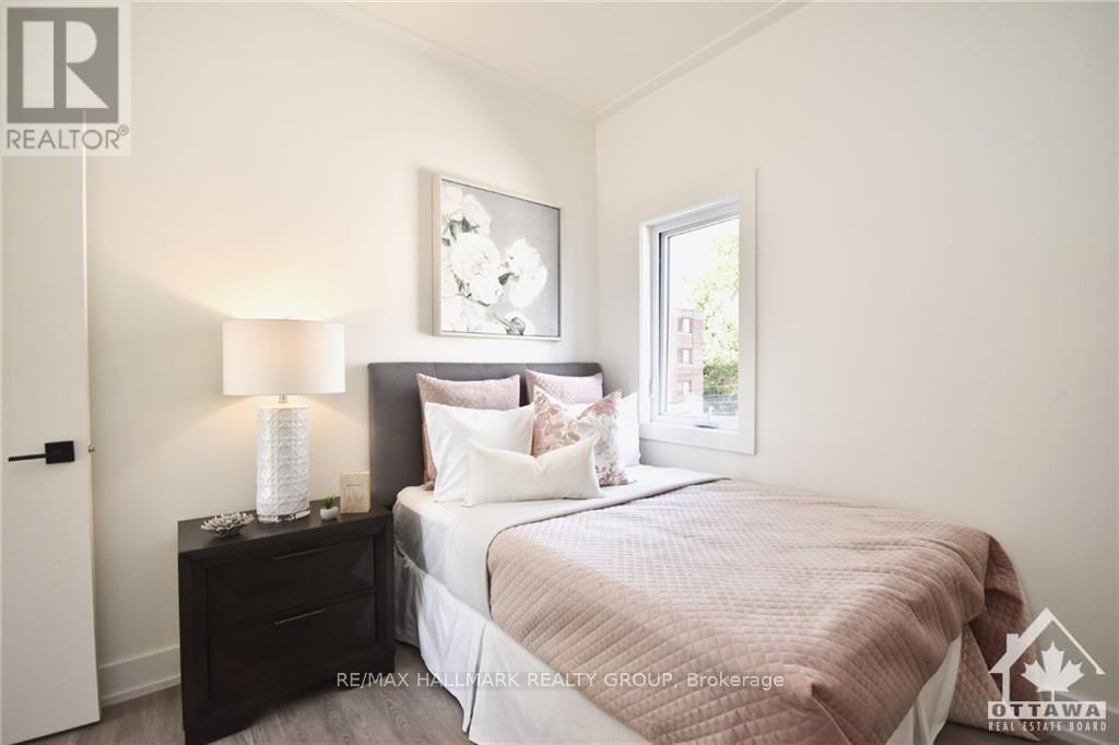 A bedroom with a bed, nightstand, and lamp.