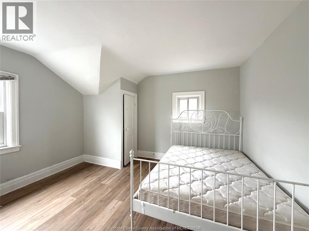 A white metal bed frame in a room with light colored walls.