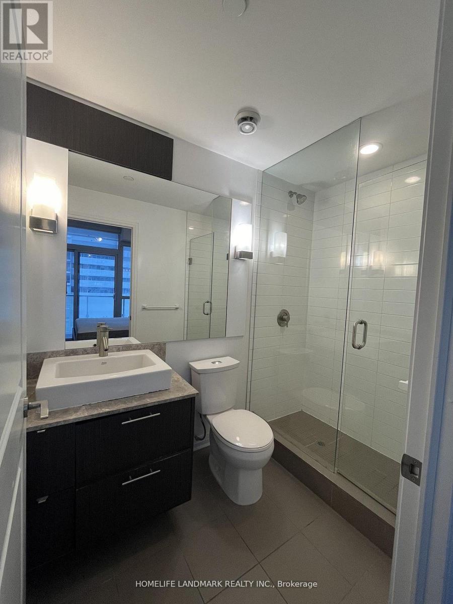 A bathroom with a sink, toilet and shower.