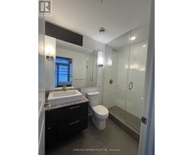 A bathroom with a sink, toilet and shower.