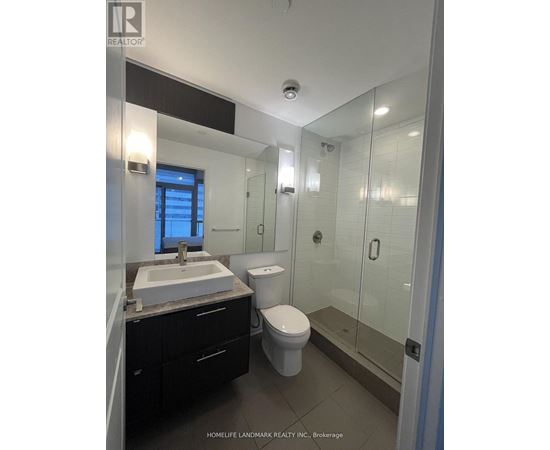 A bathroom with a sink, toilet and shower.