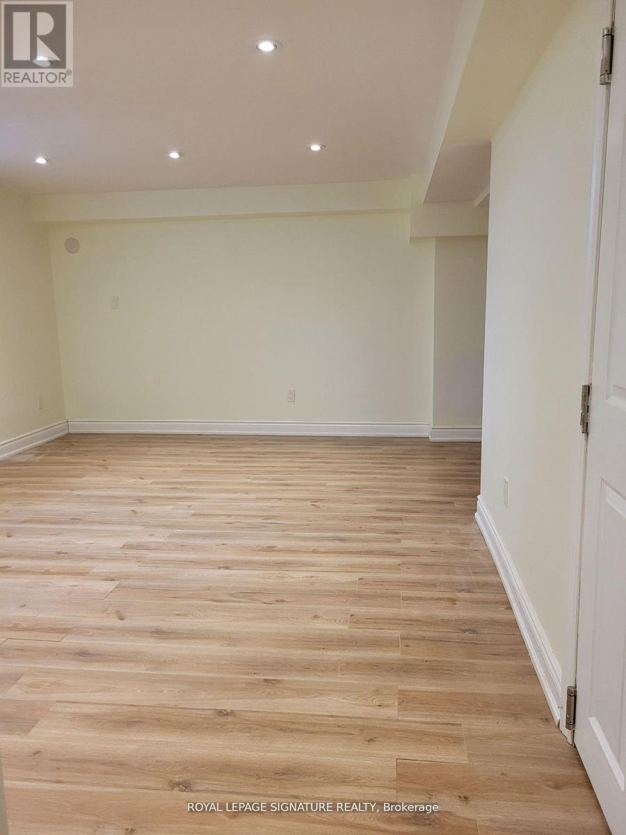 A room with wooden flooring and white walls.