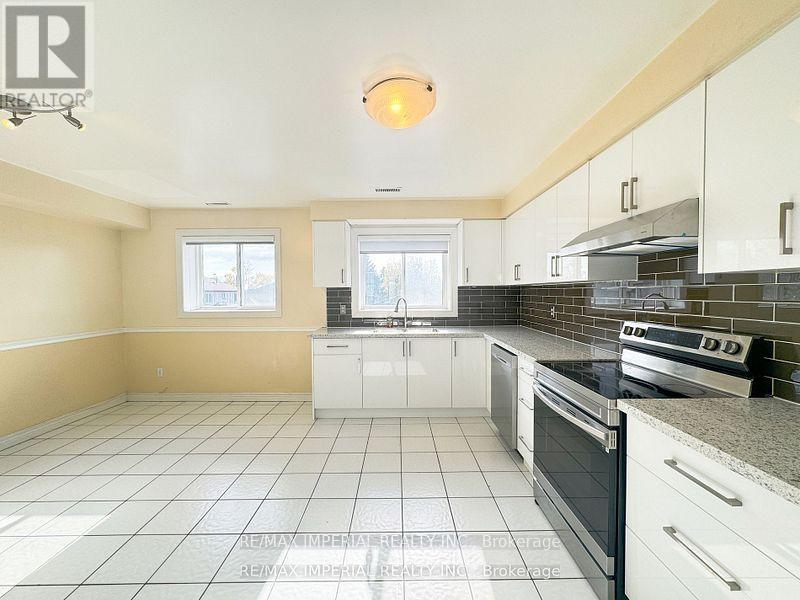 A kitchen with white cabinets and a black stove top oven.