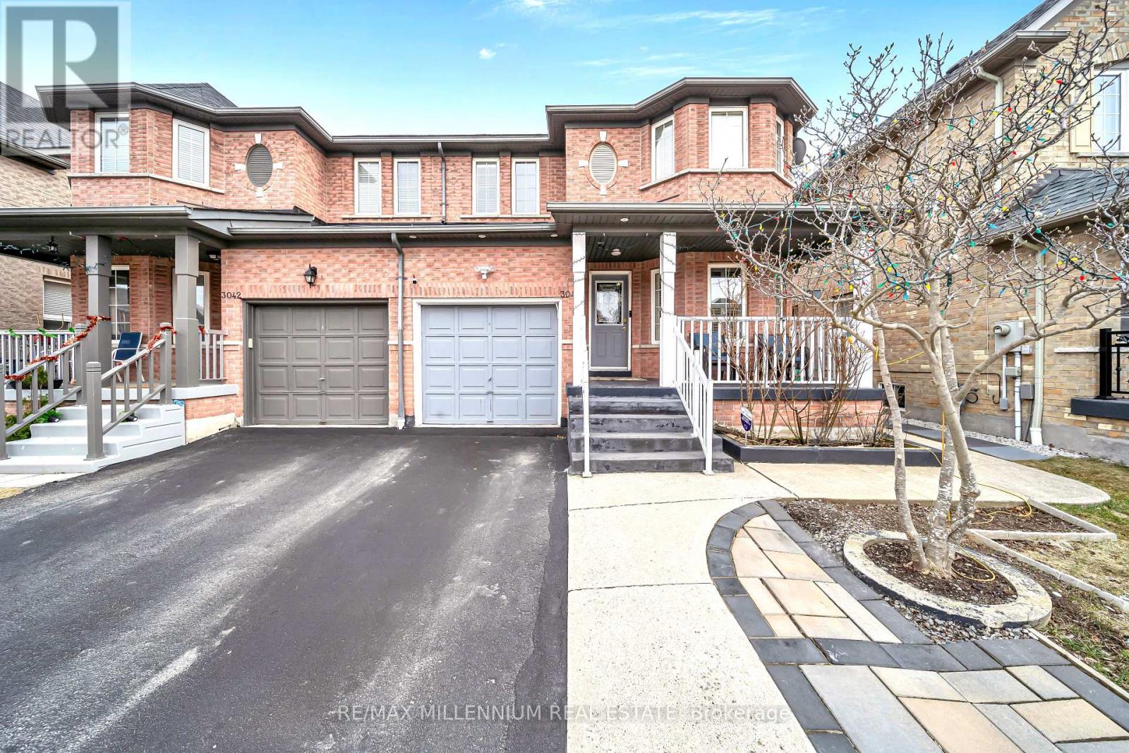 A house with a driveway and a garage is for sale.