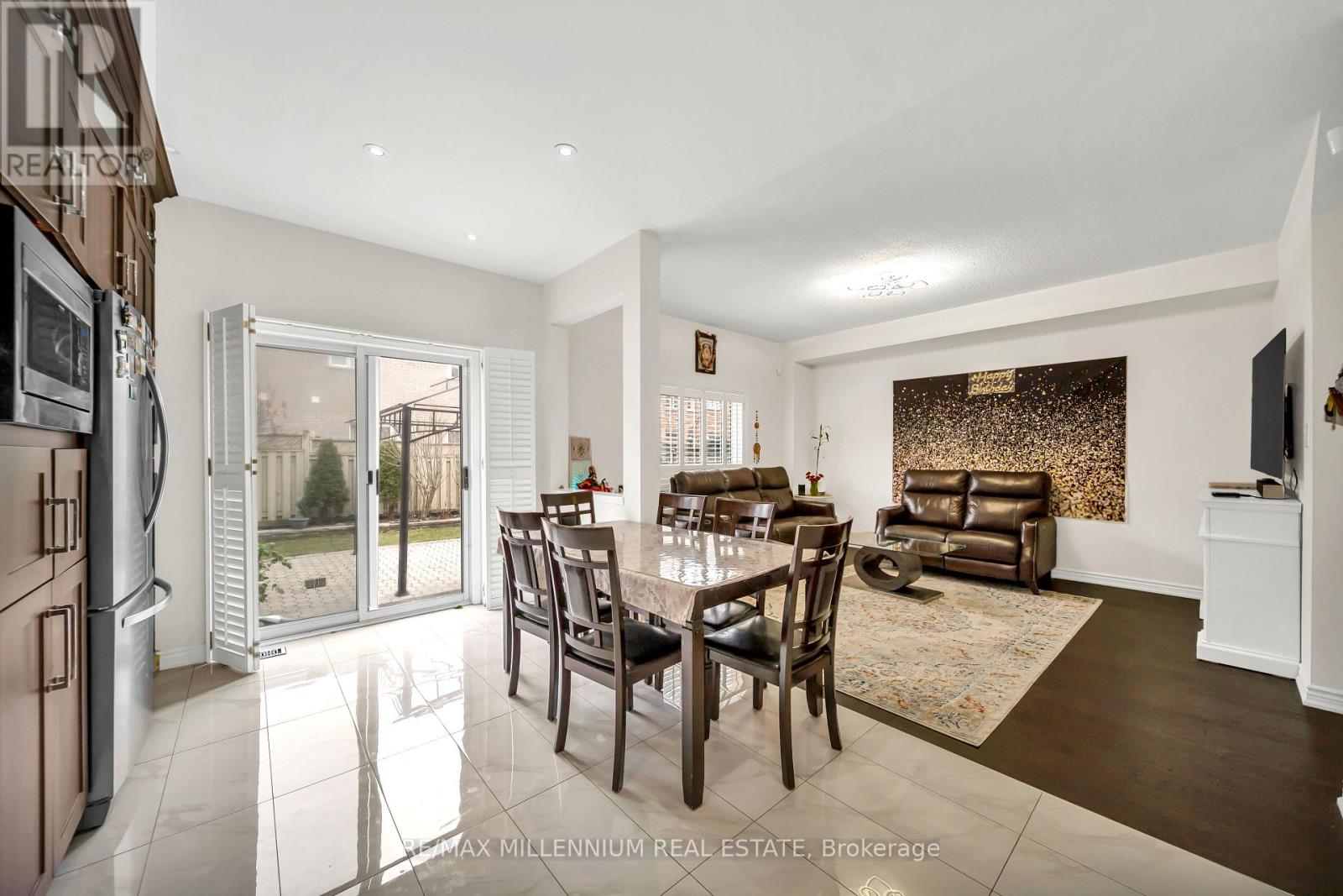 A modern dining room with a glass table and chairs.