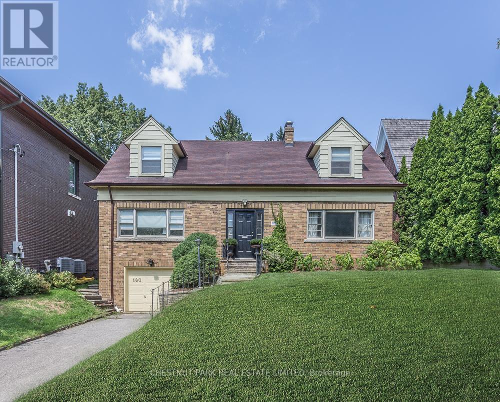 A house with a brown roof and a white garage door is for sale.