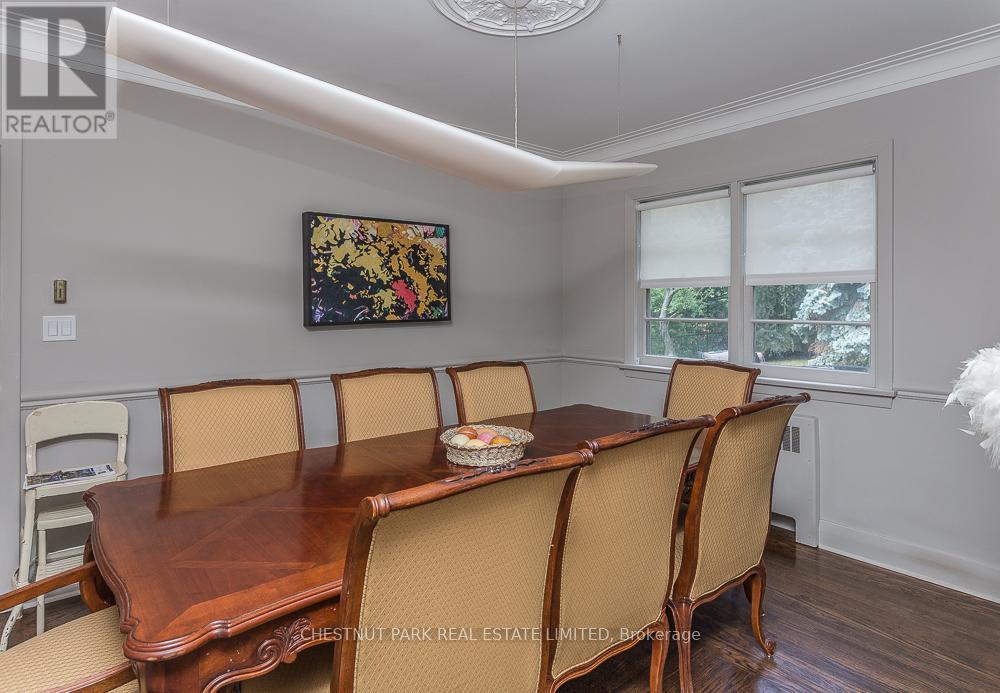 A dining room with a wooden table and chairs.