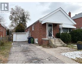 A house with a white garage door and a brick exterior.