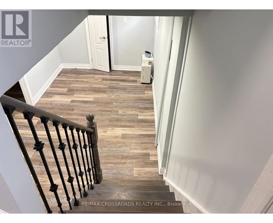 A staircase with a wooden floor and a metal railing.