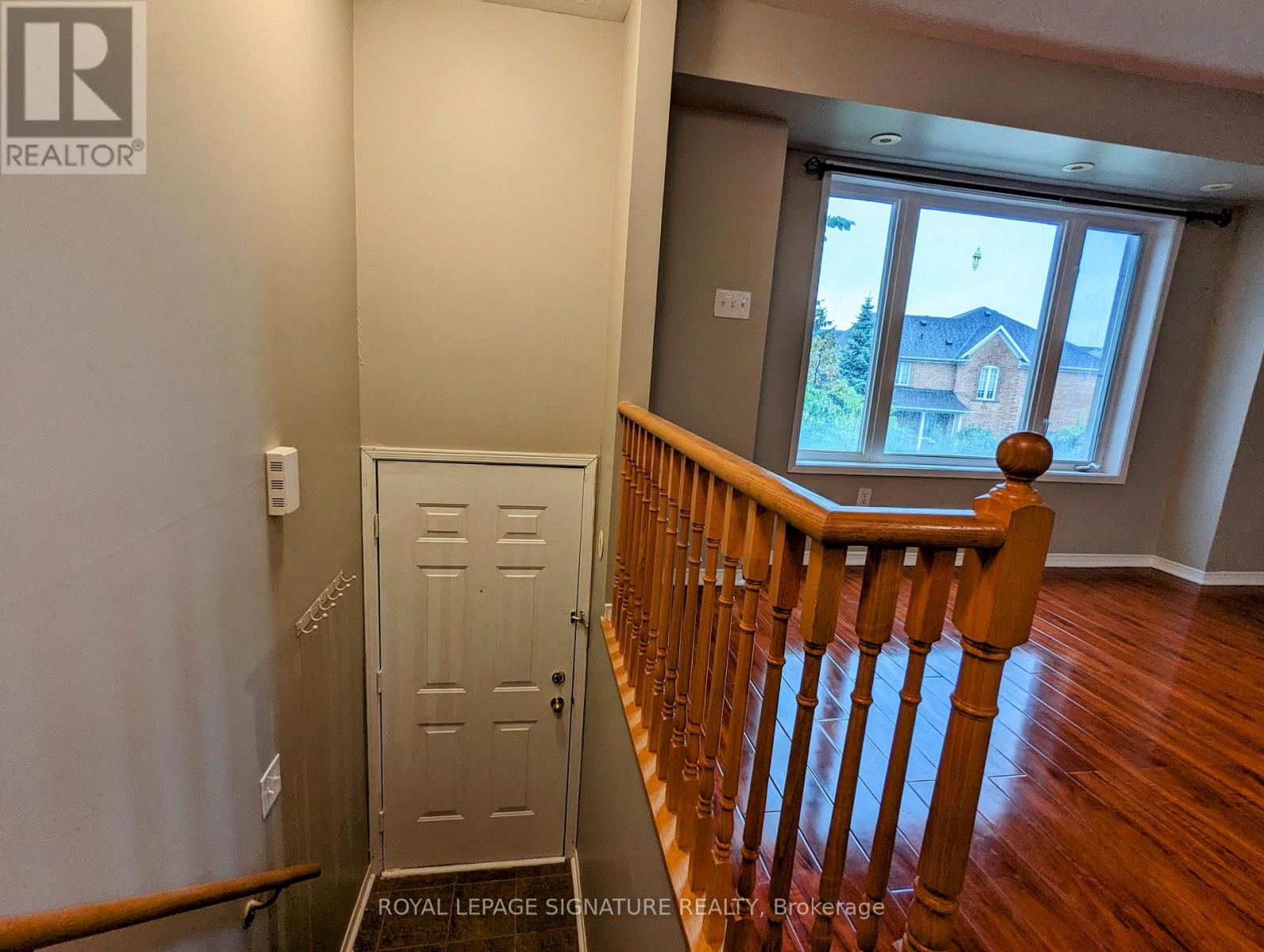 A room with a wooden staircase leading to a door.