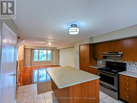 A kitchen with a stove top oven and a counter top.