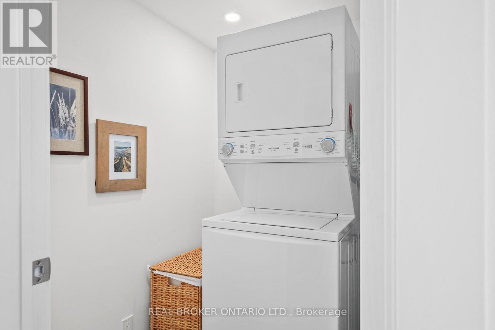 A white oven in a kitchen with a basket underneath it.