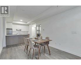 A dining room with a table set for two.