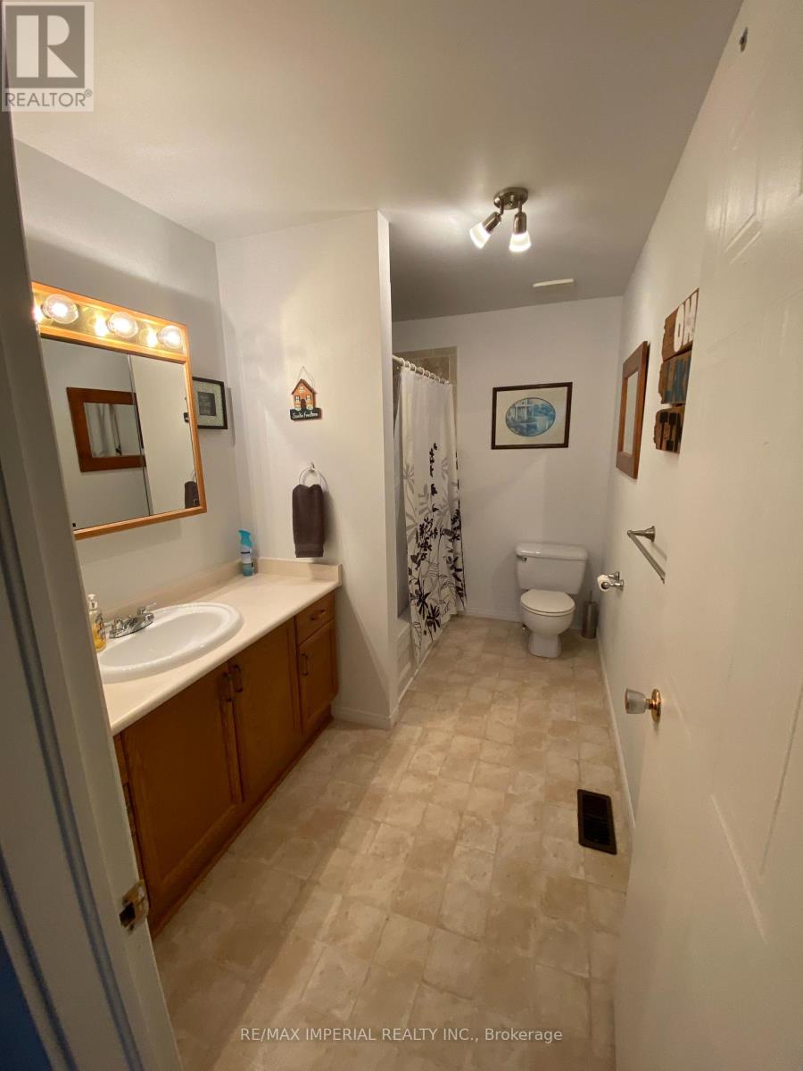 A bathroom with a sink, toilet and shower.
