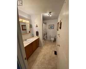 A bathroom with a sink, toilet and shower.