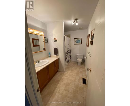 A bathroom with a sink, toilet and shower.
