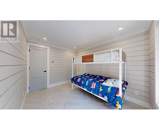 A bedroom with a bed and a small shelf above it.