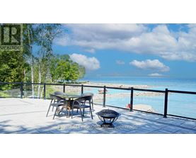 A table and chairs are set up on a patio overlooking a pool.