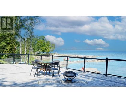 A table and chairs are set up on a patio overlooking a pool.