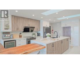 A modern kitchen with wooden cabinets and a central island.
