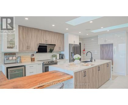 A modern kitchen with wooden cabinets and a central island.