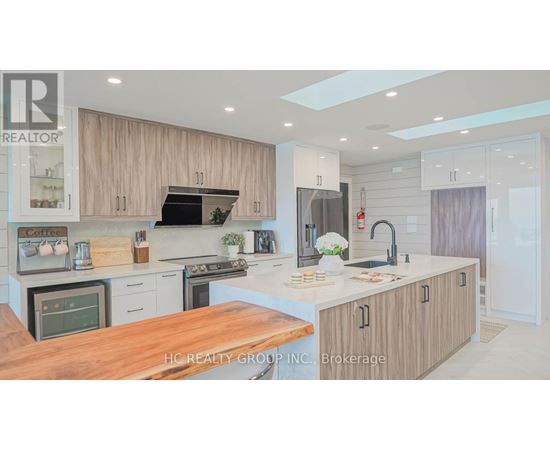 A modern kitchen with wooden cabinets and a central island.