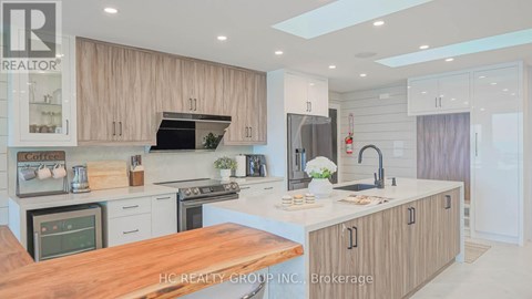 A modern kitchen with wooden cabinets and a central island.