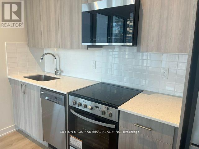 A kitchen with a stove top oven and a microwave above it.