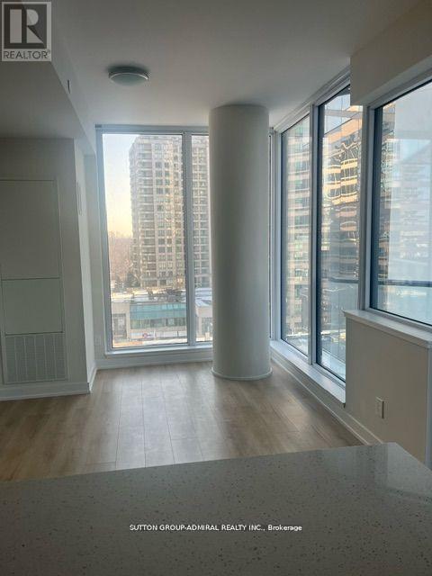 A realtor sign is on the wall in this empty room.