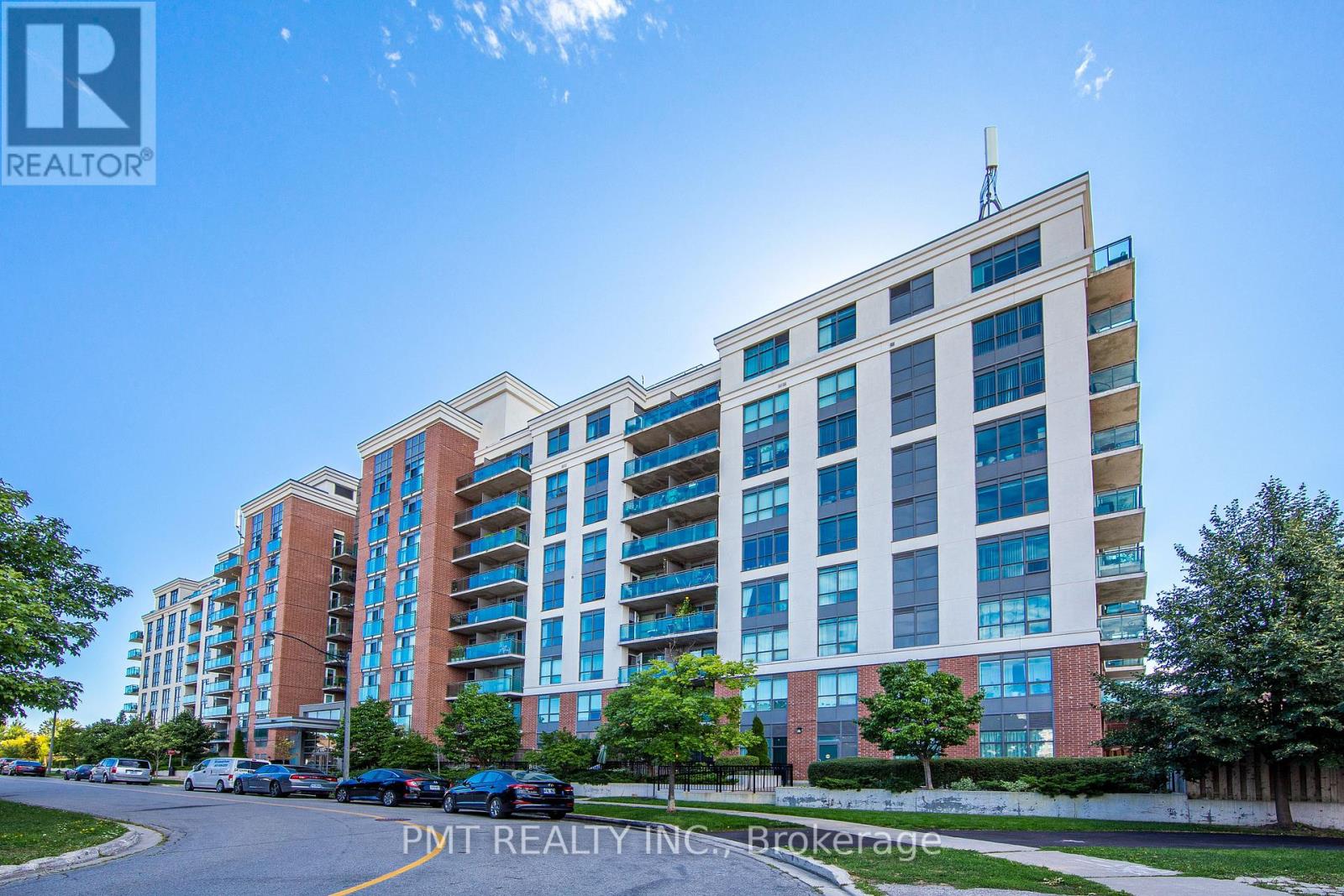 A tall apartment building with a clear blue sky in the background.