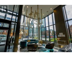 A modern interior space with a view of the city through large windows.