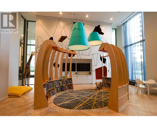 A modern living room with a wooden bookshelf and a giraffe statue.
