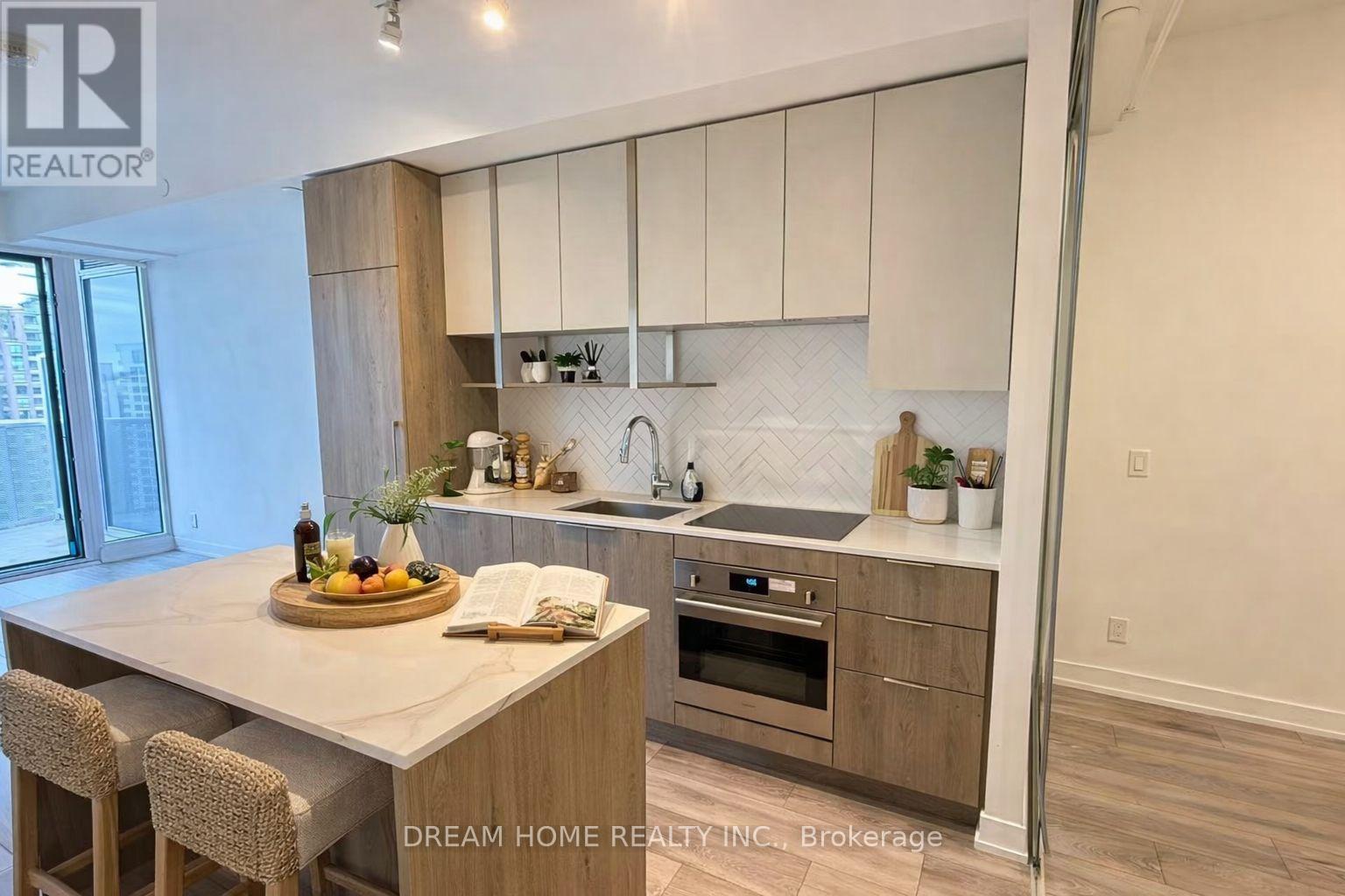 A modern kitchen with wooden cabinets and a central island.