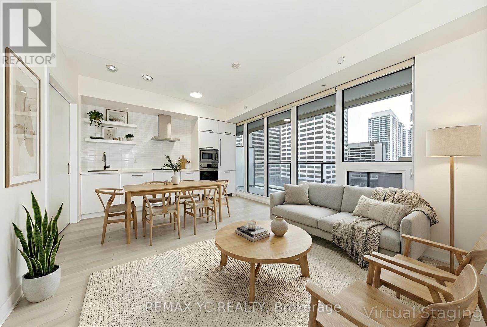 A modern living room with a dining table and chairs.
