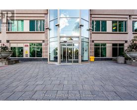 The image shows the entrance to a building with glass doors and windows.