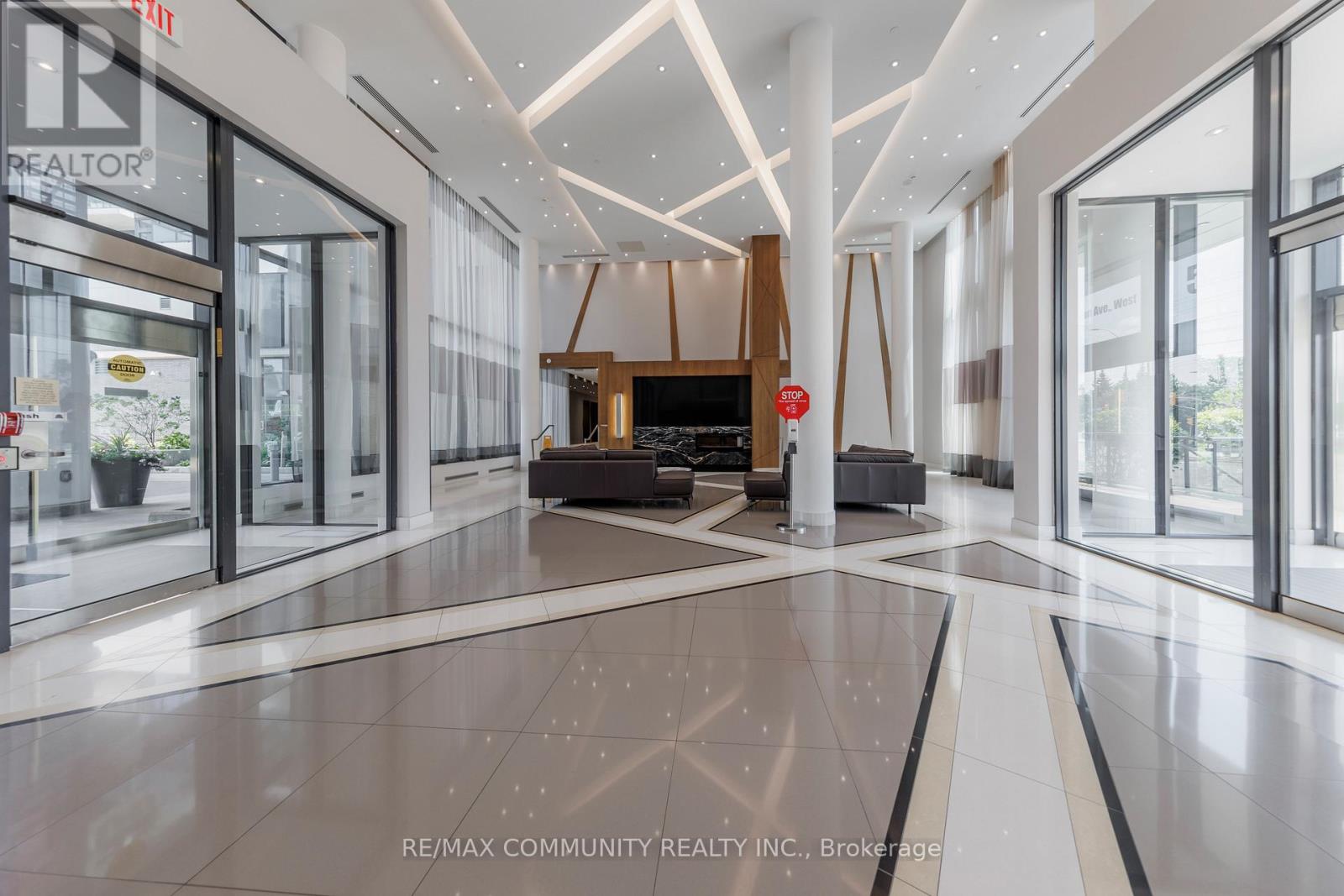 A spacious lobby with a reception desk and a large window.