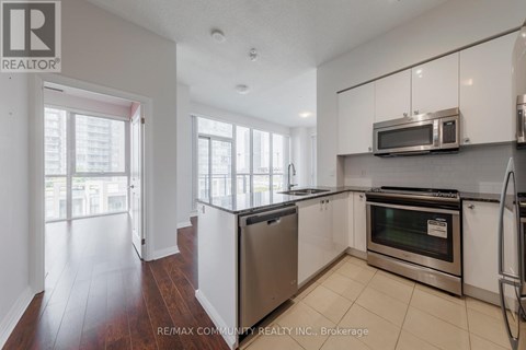 A kitchen with white cabinets and stainless steel appliances.