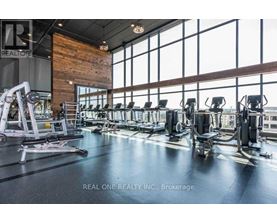 A gym with a variety of equipment including treadmills, weights, and exercise machines.