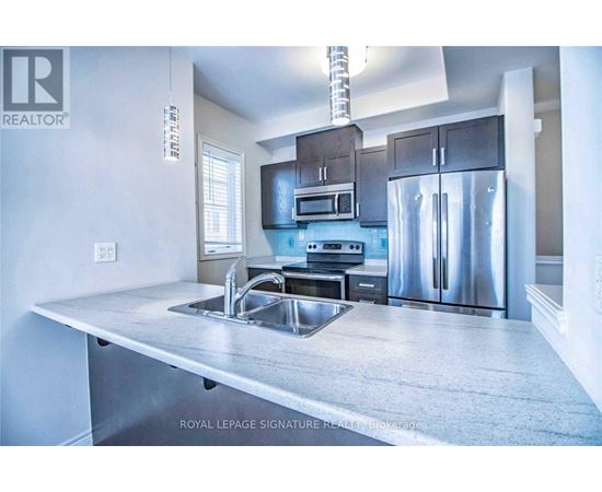 A modern kitchen with stainless steel appliances and a large island.