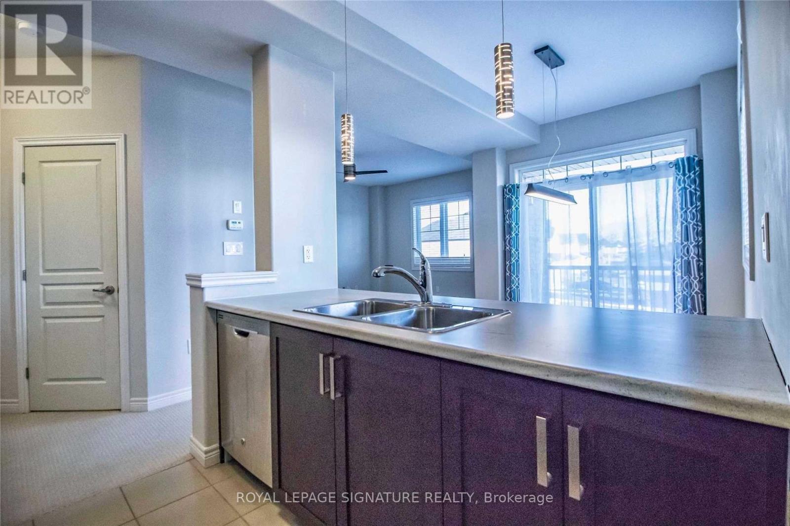 A kitchen with purple cabinets and a sink.