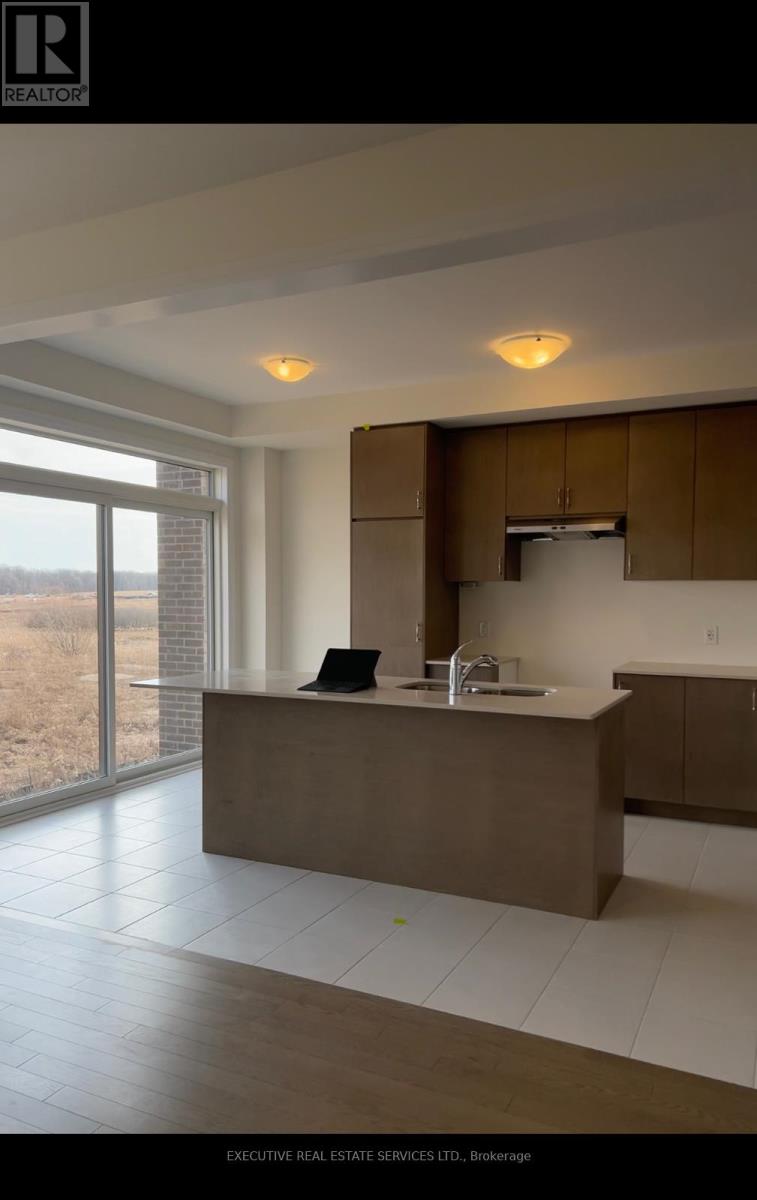 A modern kitchen with a large island and a view of the outdoors.
