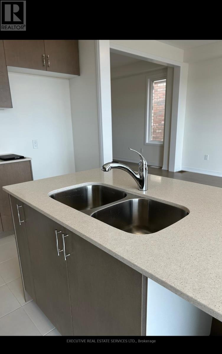 A modern kitchen with a double sink and a window.
