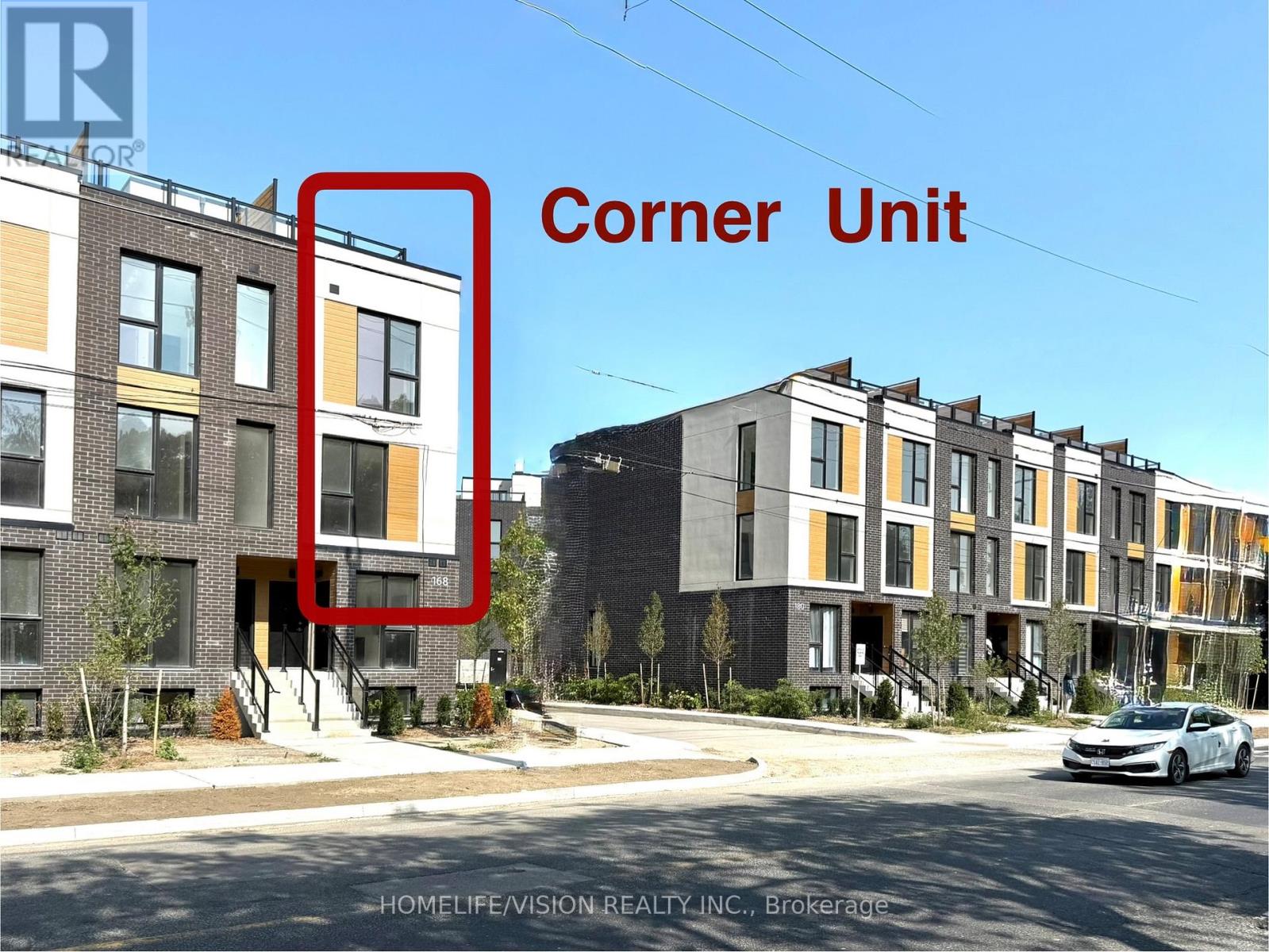 A street view of a row of townhouses with a corner unit highlighted.
