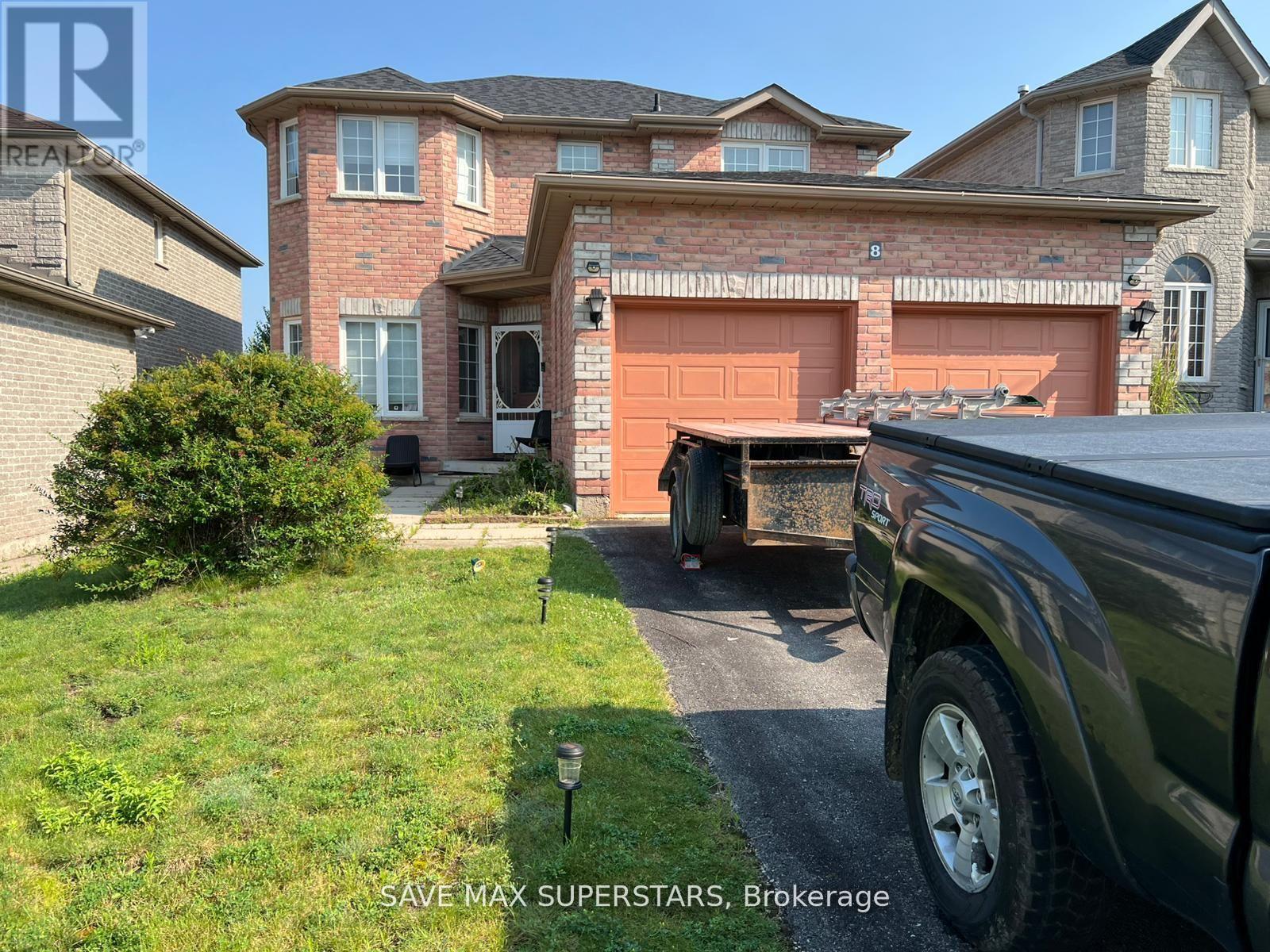 A truck is parked in front of a house with a sign that says "SAVE MAX SUPERSTARS, Brokerage".
