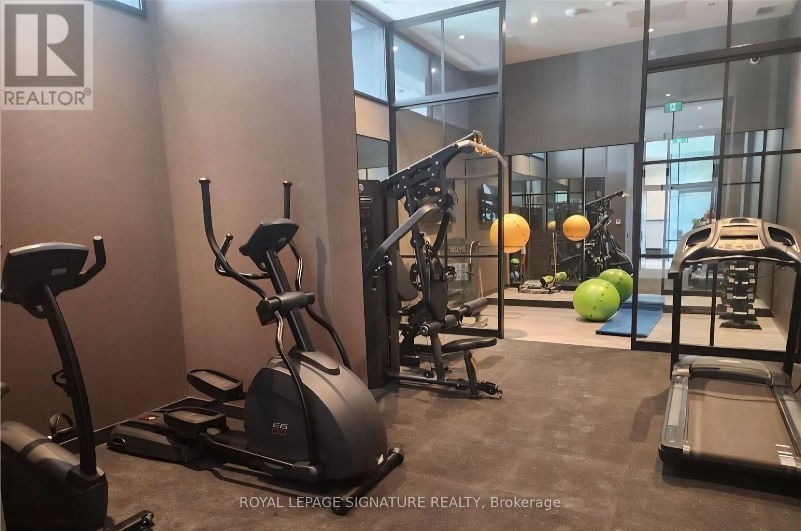 A gym with a treadmill, elliptical trainer, and other exercise equipment.