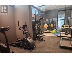 A gym with a treadmill, elliptical trainer, and other exercise equipment.