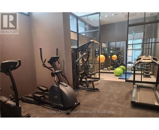 A gym with a treadmill, elliptical trainer, and other exercise equipment.