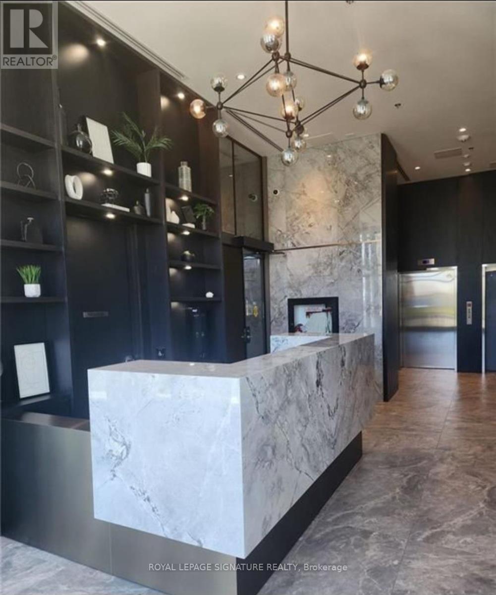 A reception area with a marble counter and a chandelier.