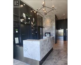 A reception area with a marble counter and a chandelier.